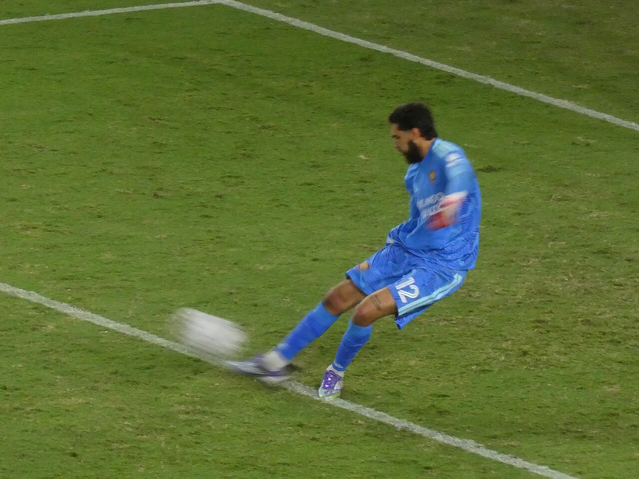 Goalkeeper setting up a long goal kick during a football match