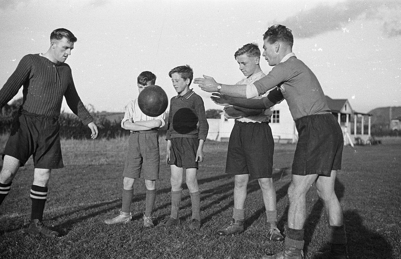 Young players running through a football training drill